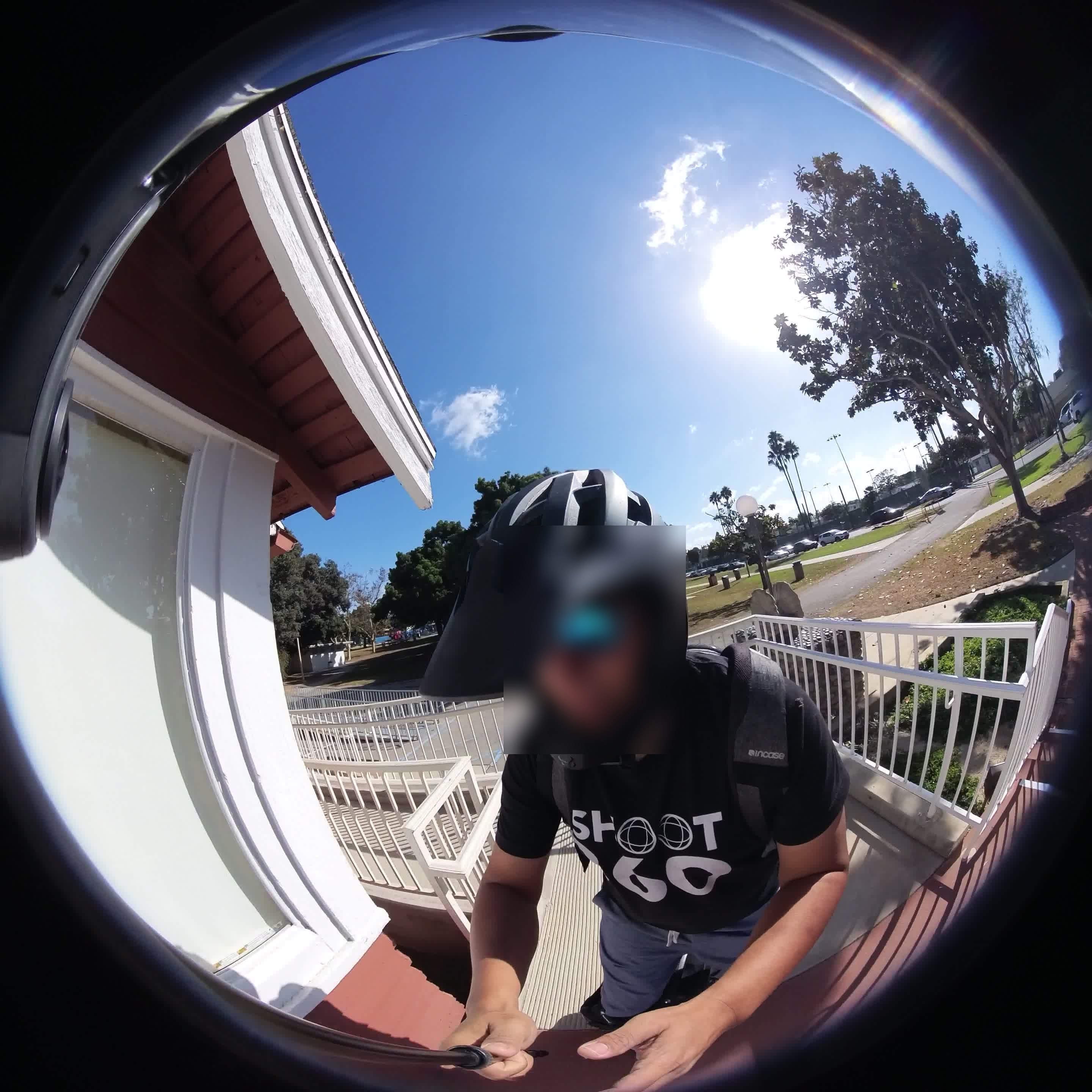 A first-person cycling frame with the rider’s face irreversibly blurred, the rest of the scene left intact.